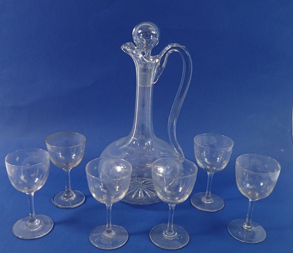 An Edwardian glass decanter and six matching sherry glasses all engraved stars