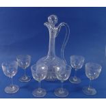 An Edwardian glass decanter and six matching sherry glasses all engraved stars