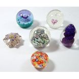 Six various glass paperweights including three by Caithness