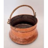 A 19th century large copper coal bucket with swing handle, 36cm diameter