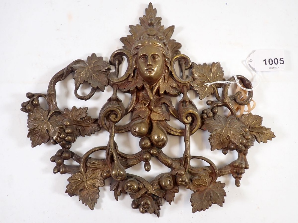 A 19th century cast brass pierced mask and vine plaque, 22 x 25cm