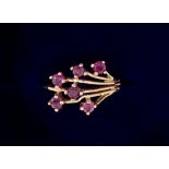 A 9 carat gold ring set spray of six rubies, size H, 1.5g