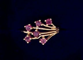 A 9 carat gold ring set spray of six rubies, size H, 1.5g