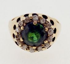 An 18 carat gold diamond and emerald cluster ring, size M, 7.2g