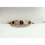 An 18 carat gold garnet and diamond ring, size M, 3.2g