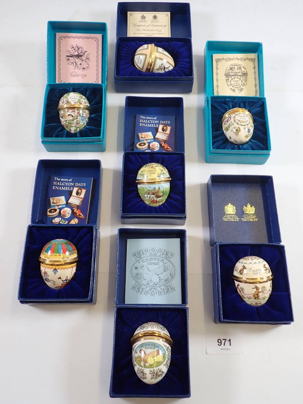 Seven Halcyon enamel Easter eggs in presentation boxes with certificates