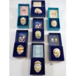 Seven Halcyon enamel Easter eggs in presentation boxes with certificates