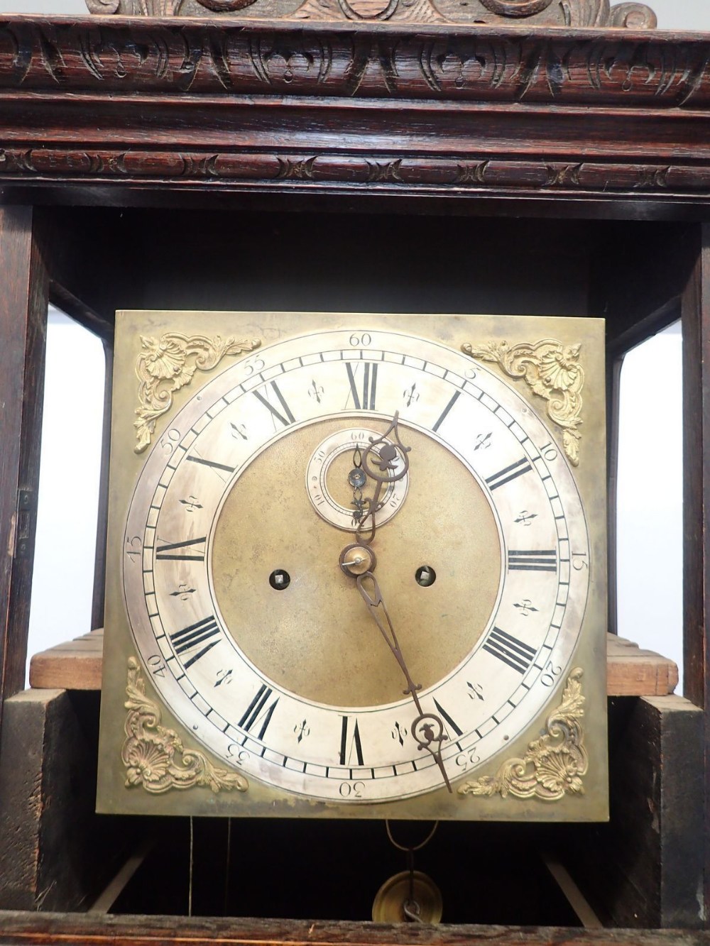 A 19th century continental oak cased longcase clock with square brass dial, the case ornately carved - Image 2 of 4