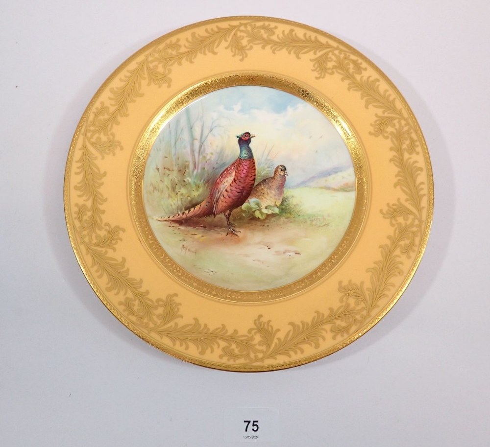 A Minton plate painted pheasants by A Holland within yellow and gilt border, 27cm diameter