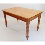 A Victorian pine farmhouse dining table with frieze drawer and turned supports, 137 x 84 x 76cm