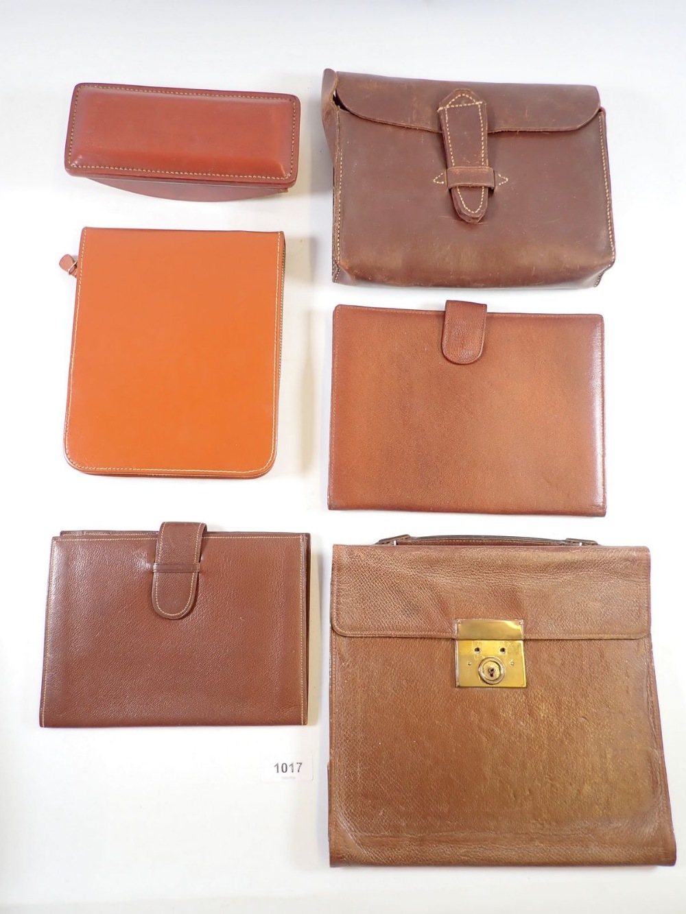 Four leather correspondence/wallets, a leather blotter and a leather pouch