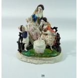 A 19th century porcelain group of lady with daughter and younger son, the mother feeding the