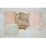 A pink and white patchwork quilt, a hand stitched pink Durham quilt, a machine made tasseled throw