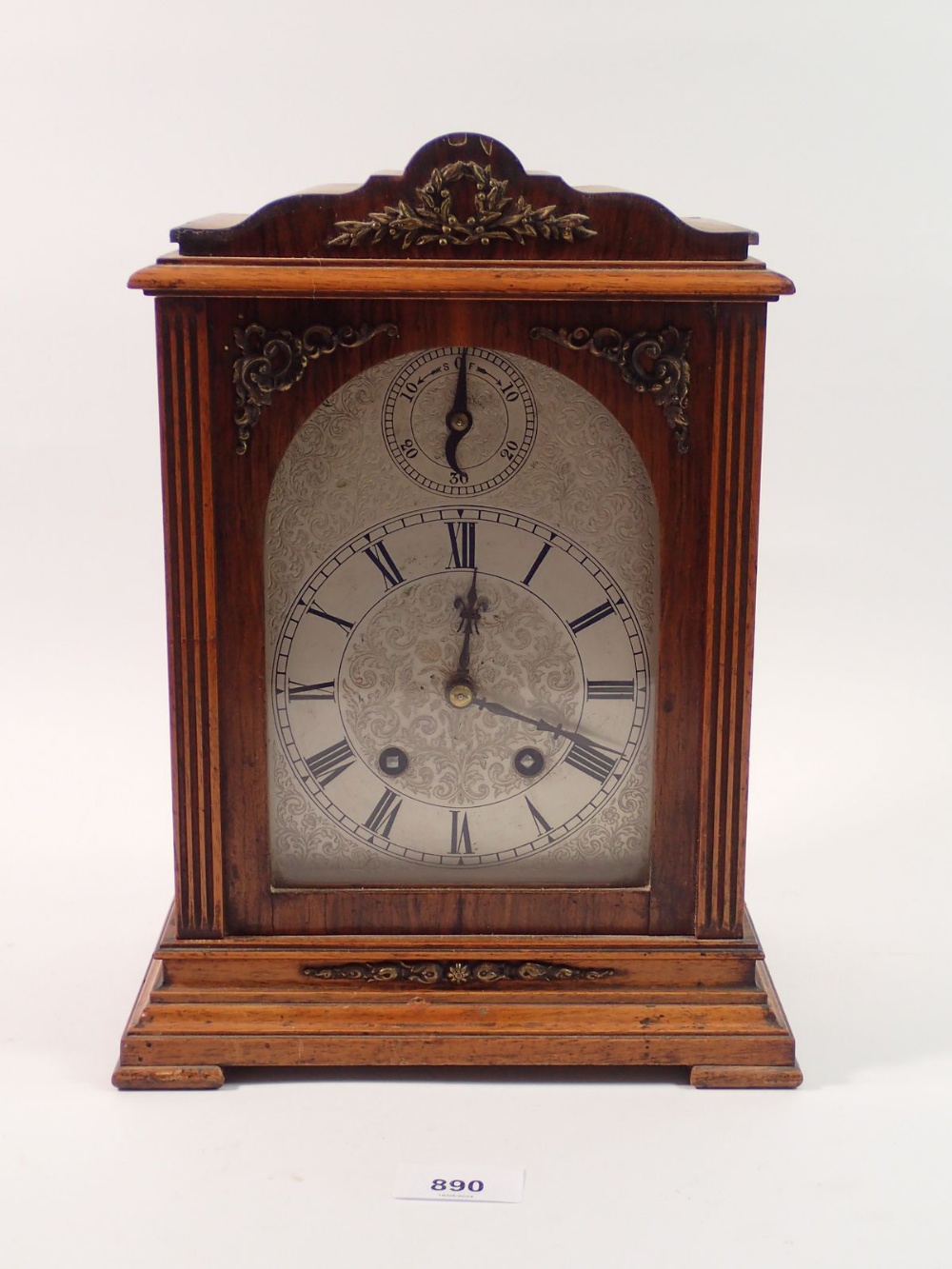 A late 19th century oak mantel clock with German movement marked Lenzkirch, the silvered face with