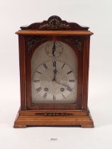 A late 19th century oak mantel clock with German movement marked Lenzkirch, the silvered face with