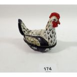 A Limoges trinket box in the form of a chicken with painted decoration, initialed E V, 10cm tall