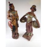 A large Native American resin figure, 61cm tall and a plaster Nubian girl holding baskets -a/f, 57cm