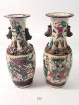 A pair of Japanese crackle glaze vases decorated warriors, 25cm tall