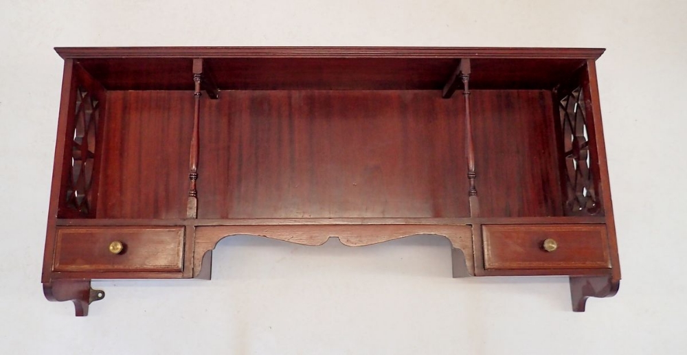 An Edwardian mahogany display shelf with pierced sides and two small drawers to apron, 84 x 35cm