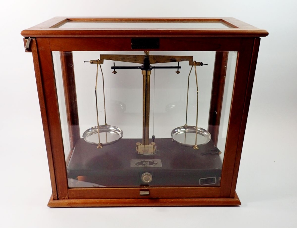 A Griffin & Tatlock set of balance scales in glazed case, 45cm wide