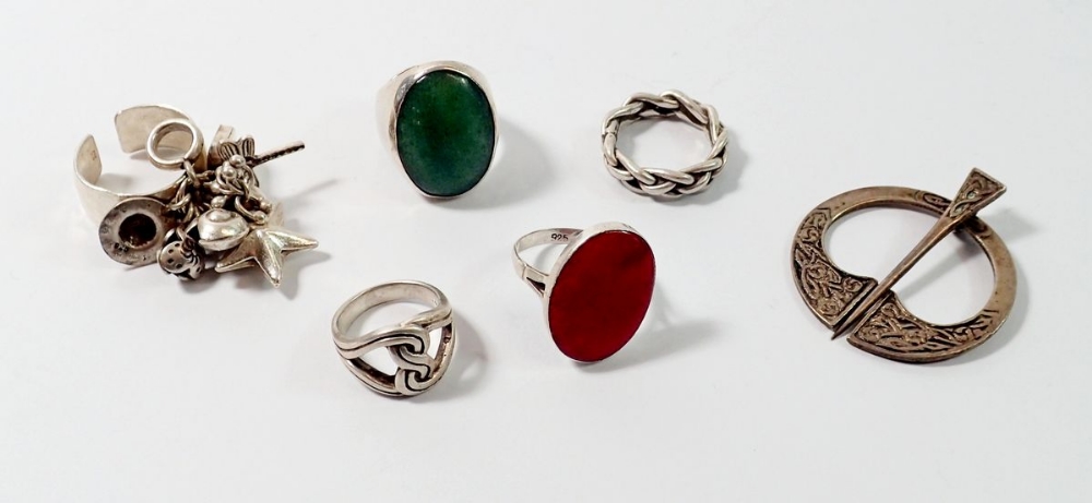 Five silver ethnic style rings and a silver kilt pin