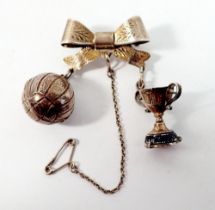A silver ribbon form brooch suspended unusual football and trophy cup charms, 15g