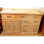 A 19th century pine side cabinet with three frieze drawers over cupboard and three further