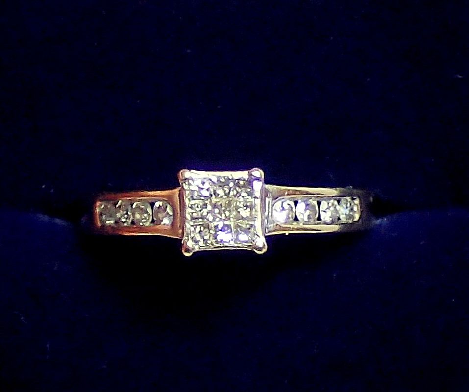 An 18 carat white gold ring set square panel of nine chip diamonds on diamond set shoulders, size L,