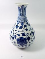 A Chinese blue and white baluster vase decorated peony and trailing leaves, 34cm tall