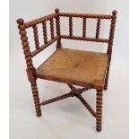 An Arts & Crafts William Morris style bobbin turned corner chair with rush seat