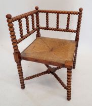 An Arts & Crafts William Morris style bobbin turned corner chair with rush seat
