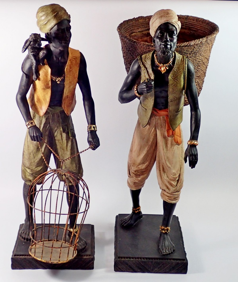 Two large African Indian decorative resin figures, man with monkey and cage and man with fruit