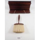 A rosewood bookrest and a rosewood hat brush