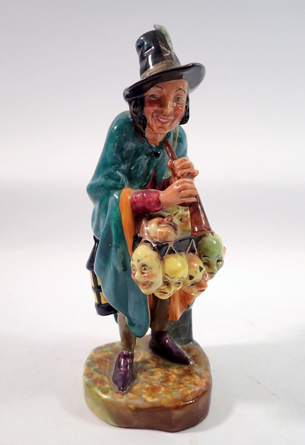 A Royal Doulton figure 'The Mask Seller' HN2103