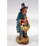 A Royal Doulton figure 'The Mask Seller' HN2103