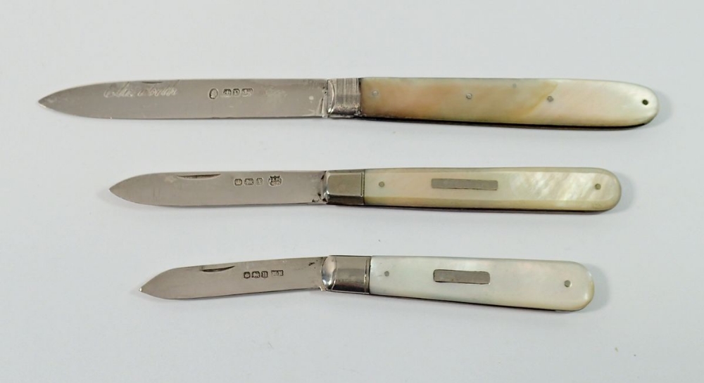 Three silver and mother of pearl folding fruit knives