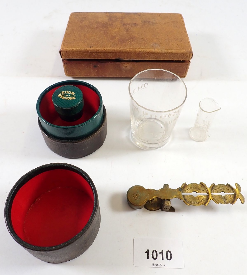 A vintage medicine measure in leather case, a leather travelling jewellery case and a sovereign