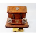 A Victorian oak correspondence box with rise top letter compartment and inkstand fitted two glass