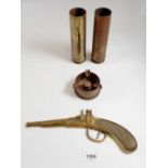 Two shell case vases and a trench art ashtray plus a gun wall ornament