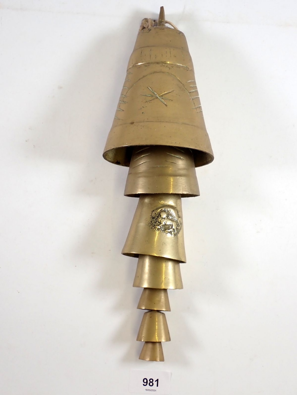 A graduated set of brass camel bells