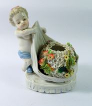 A 19th century porcelain posy vase and cherub with floral encrusted decoration, with faux Augustus