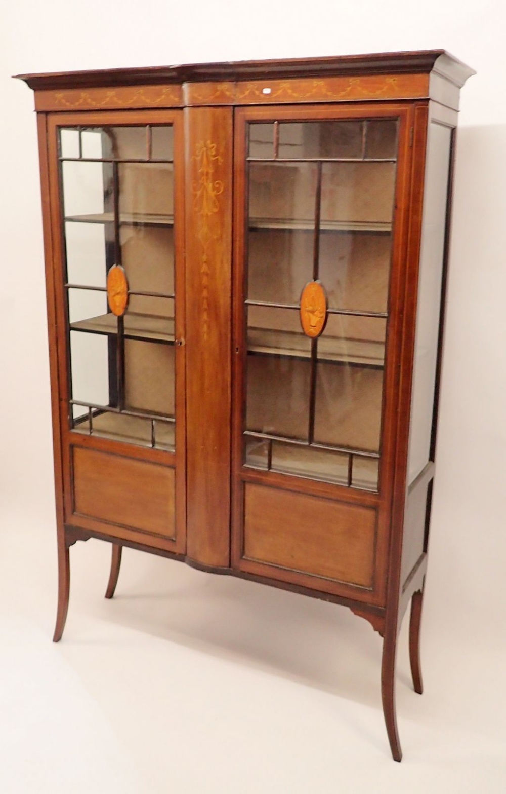 An Edwardian mahogany two door cabinet with floral basket marquetry decoration, 115cm wide x 170cm