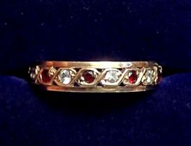 A 9 carat gold garnet and white stone eternity ring, size J to K, 2.2g