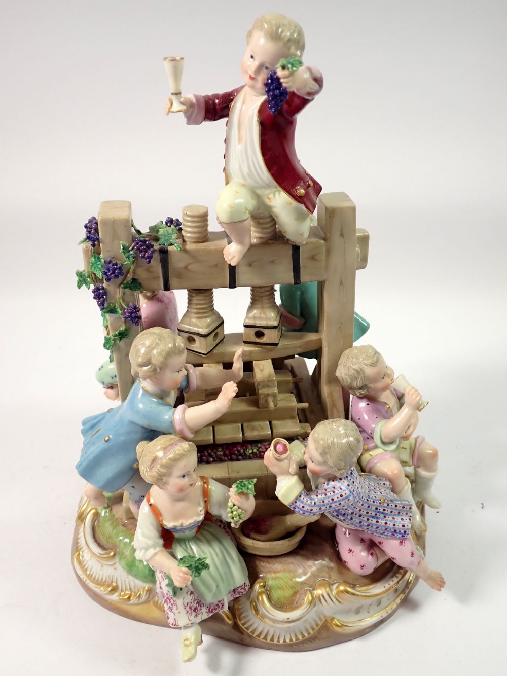 A 19th century Meissen group of children playing around a wine press, crossed swords mark to base, - Image 2 of 7