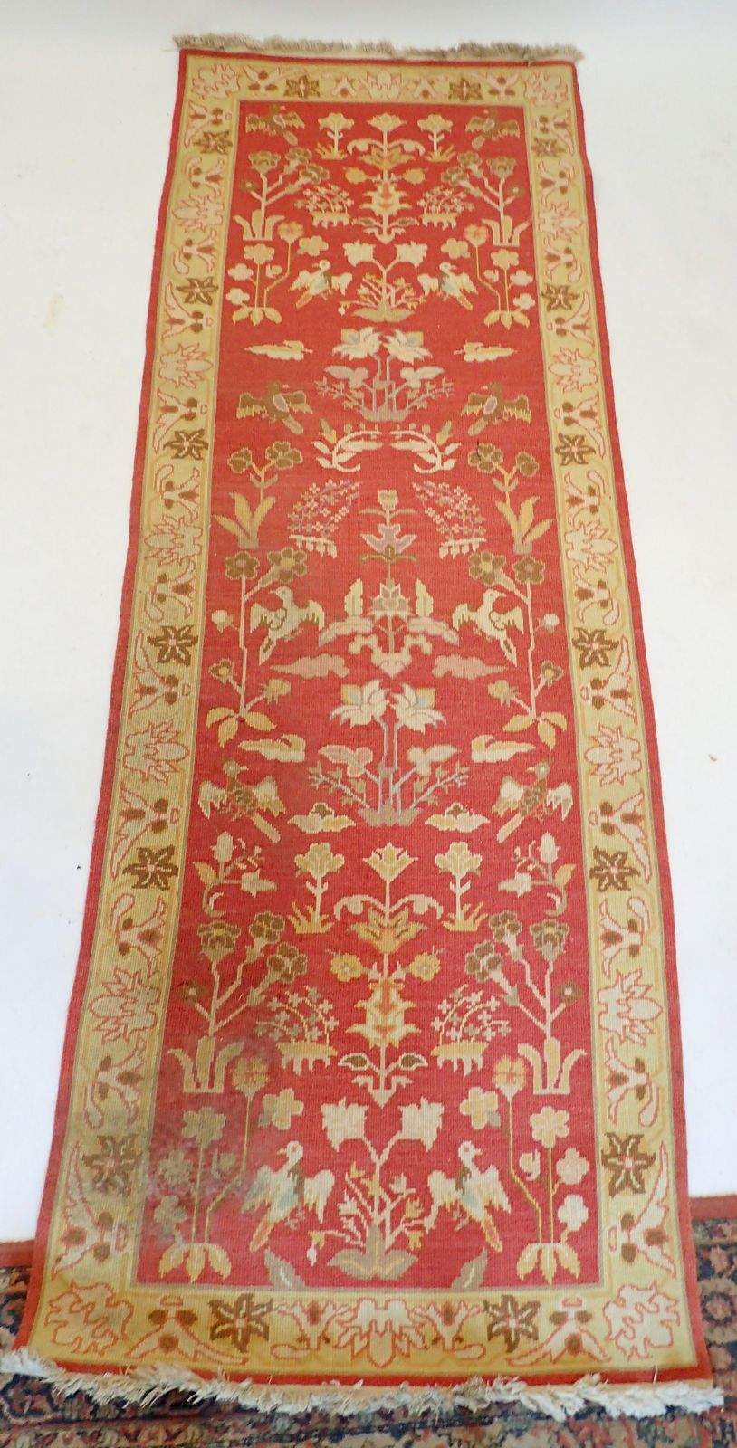 A Turkish style runner with floral design on coral ground, 271 x 93cm