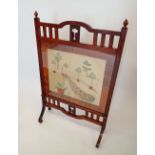 An Edwardian mahogany Arts & Crafts fire screen with slatted surround and embroidered panel, 66cm