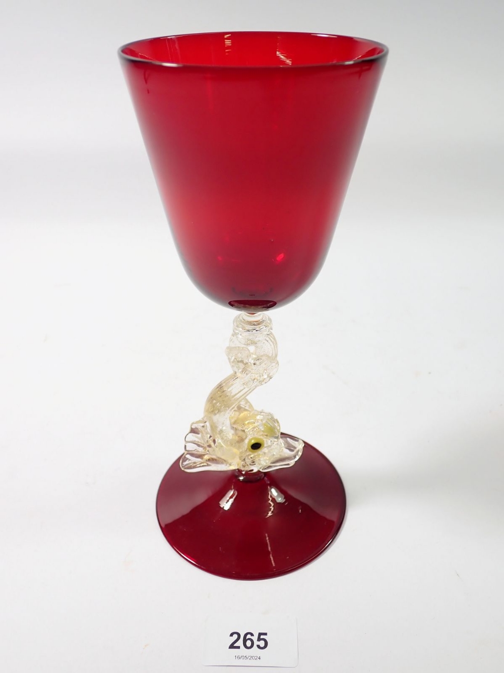 A 20th century Salviati red goblet on dolphin stem, 21cm tall