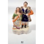 A Victorian Staffordshire group man and child seated with violin, 17cm tall