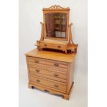 An Edwardian satinwalnut dressing table with swing mirror and trinket drawers over two short and two