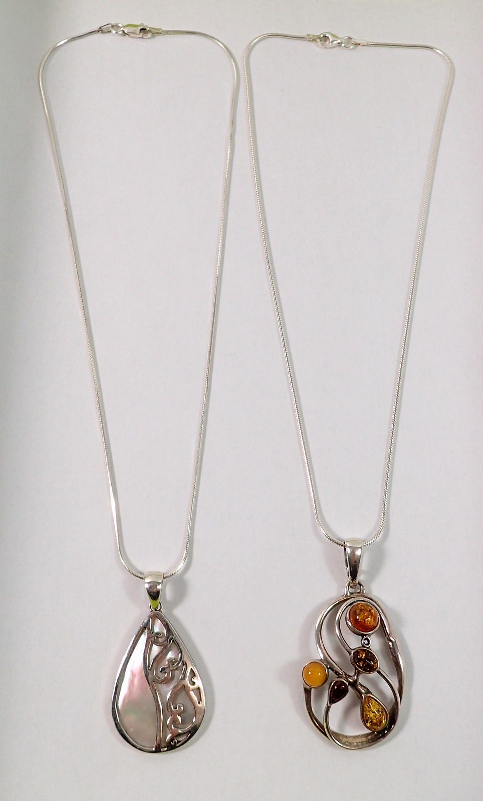 A silver and amber pendant and a silver and mother of pearl pendant on silver chain - Image 2 of 2